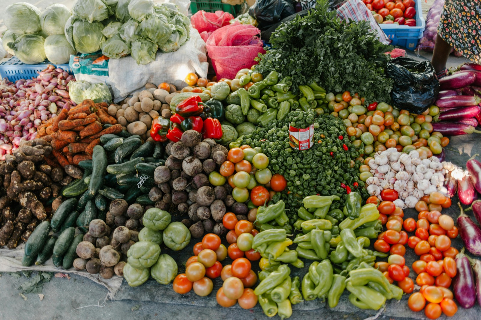 Peppers and produce piled on a market table
