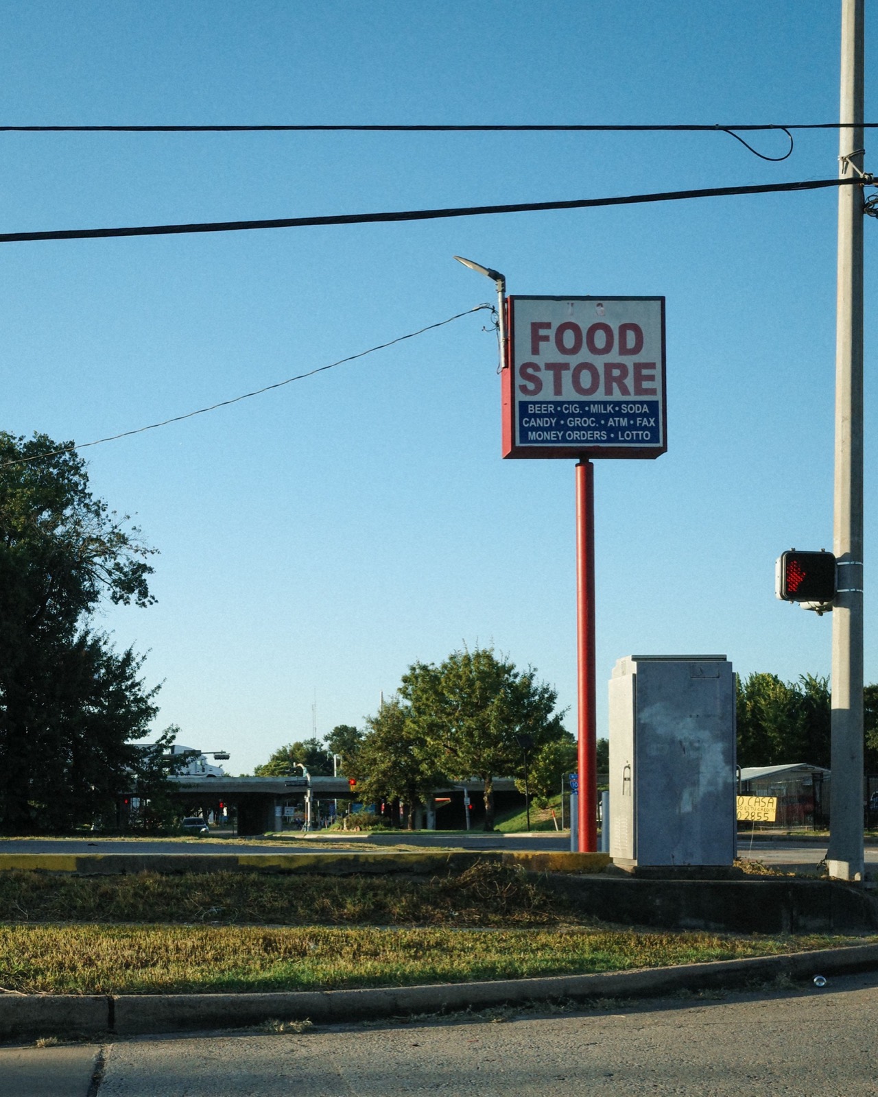 A FOOD STORE sign over an empty lot
