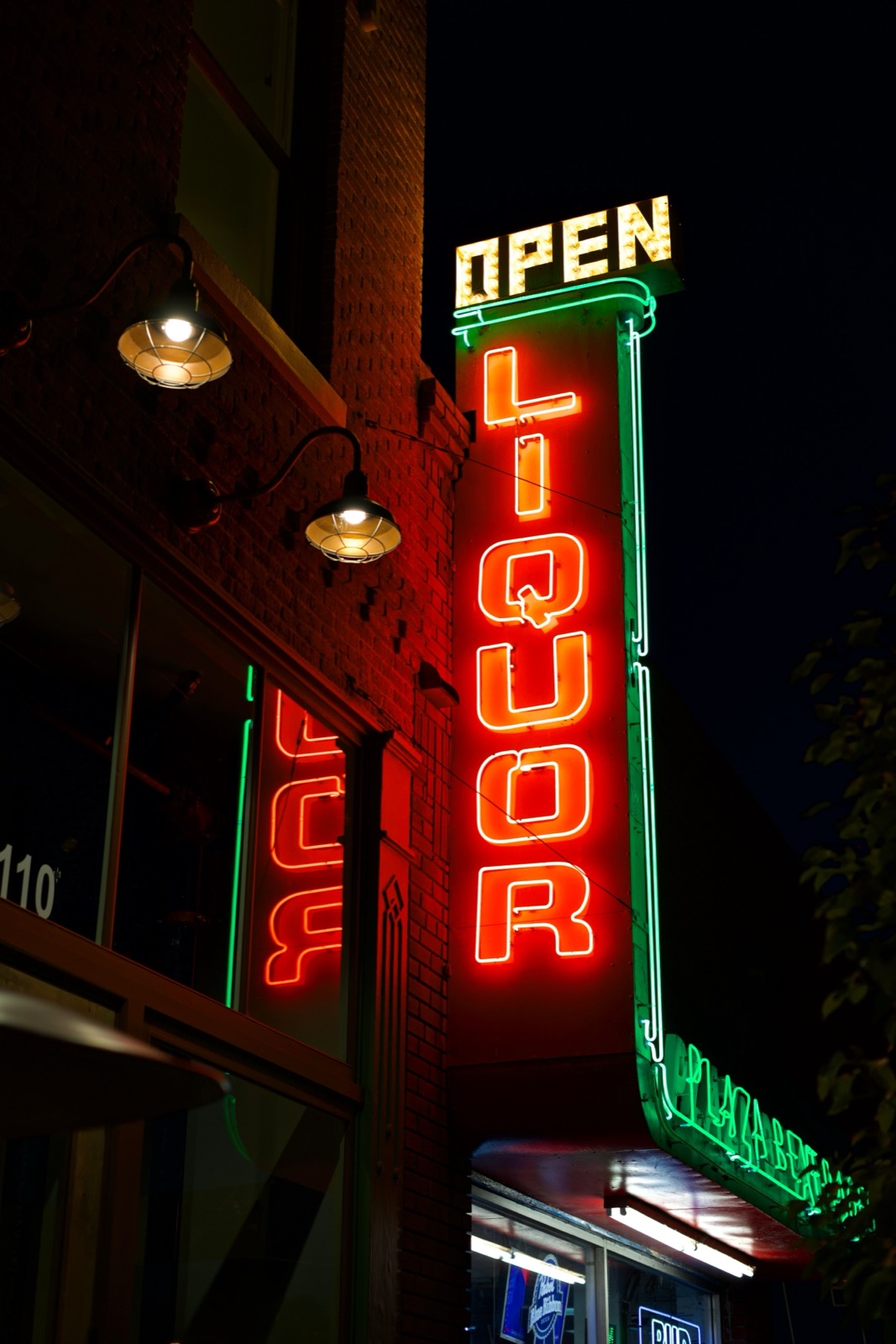 A neon LIQUOR sign at night