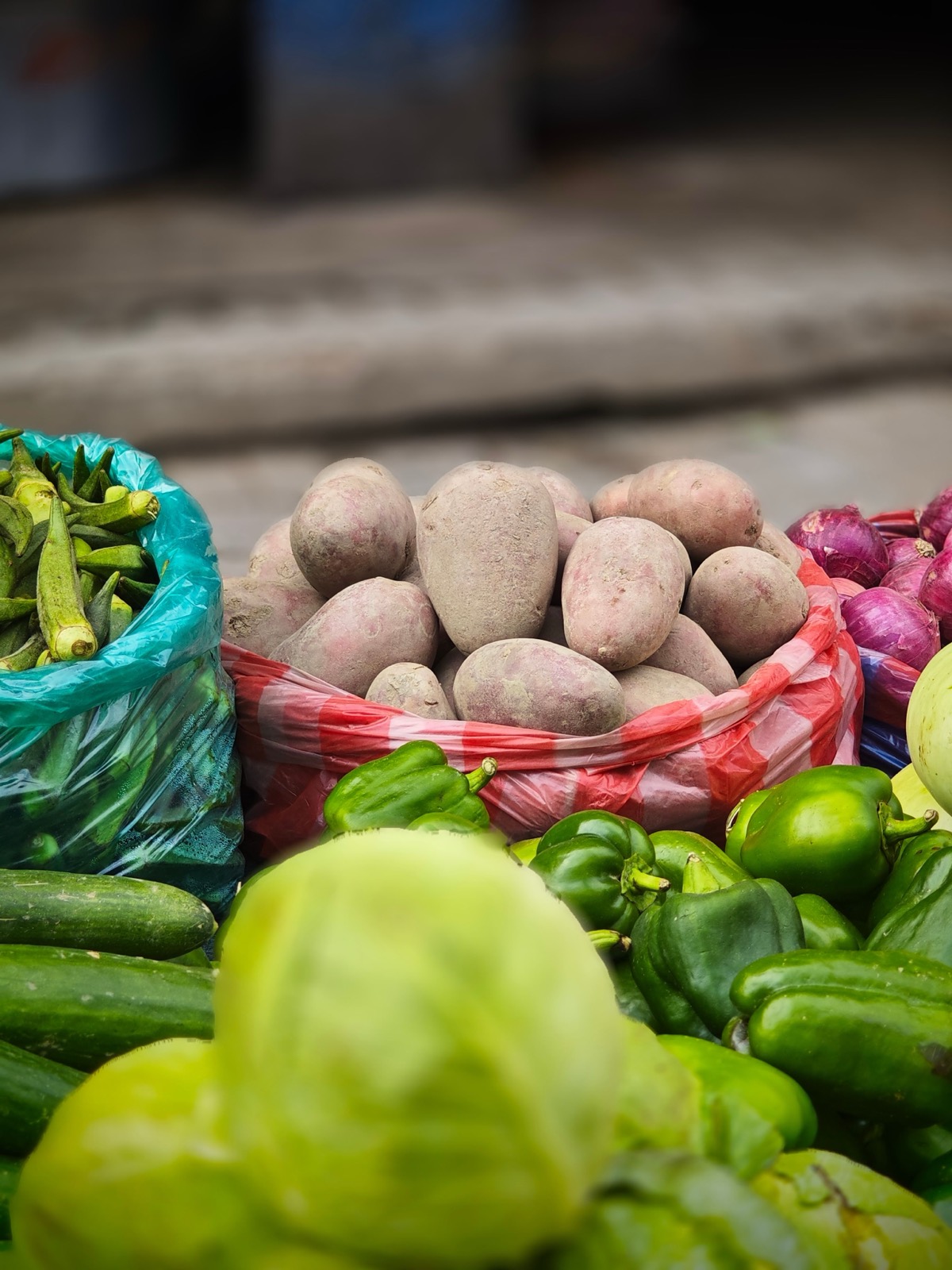 Bags of potatoes, peppers, and limes ready for market