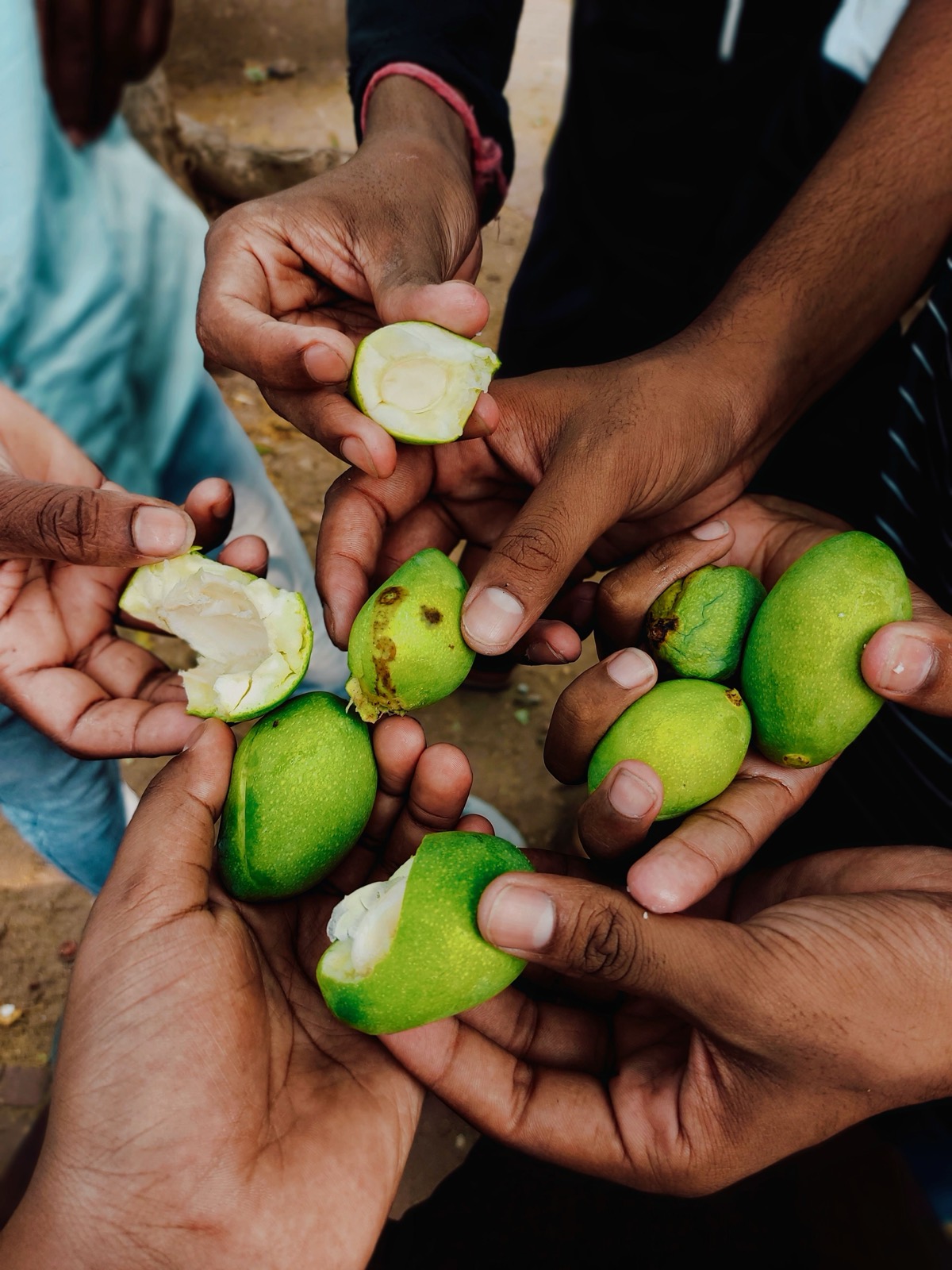 Hands share a pile of limes