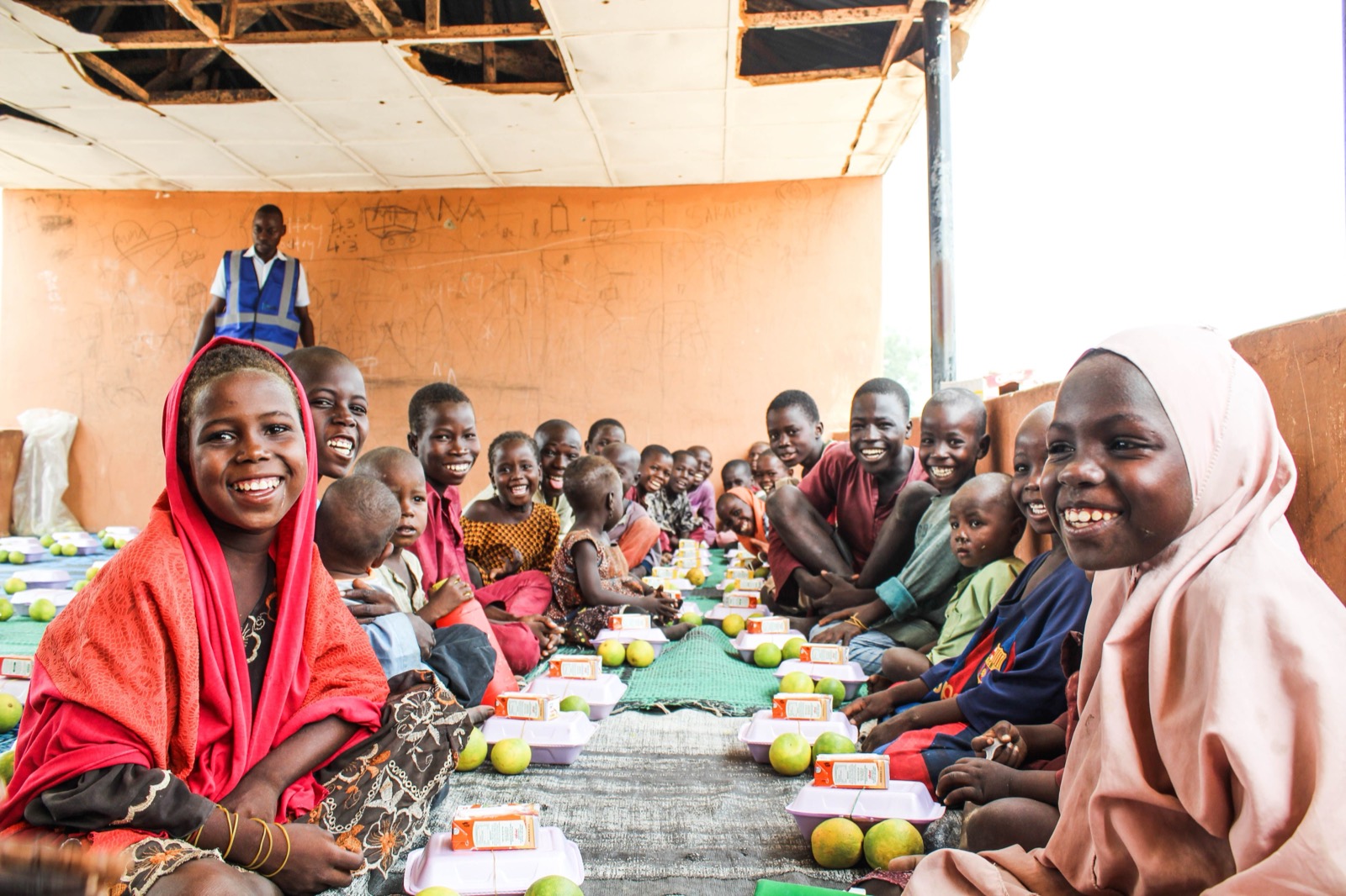 Women in bright dress share a meal together