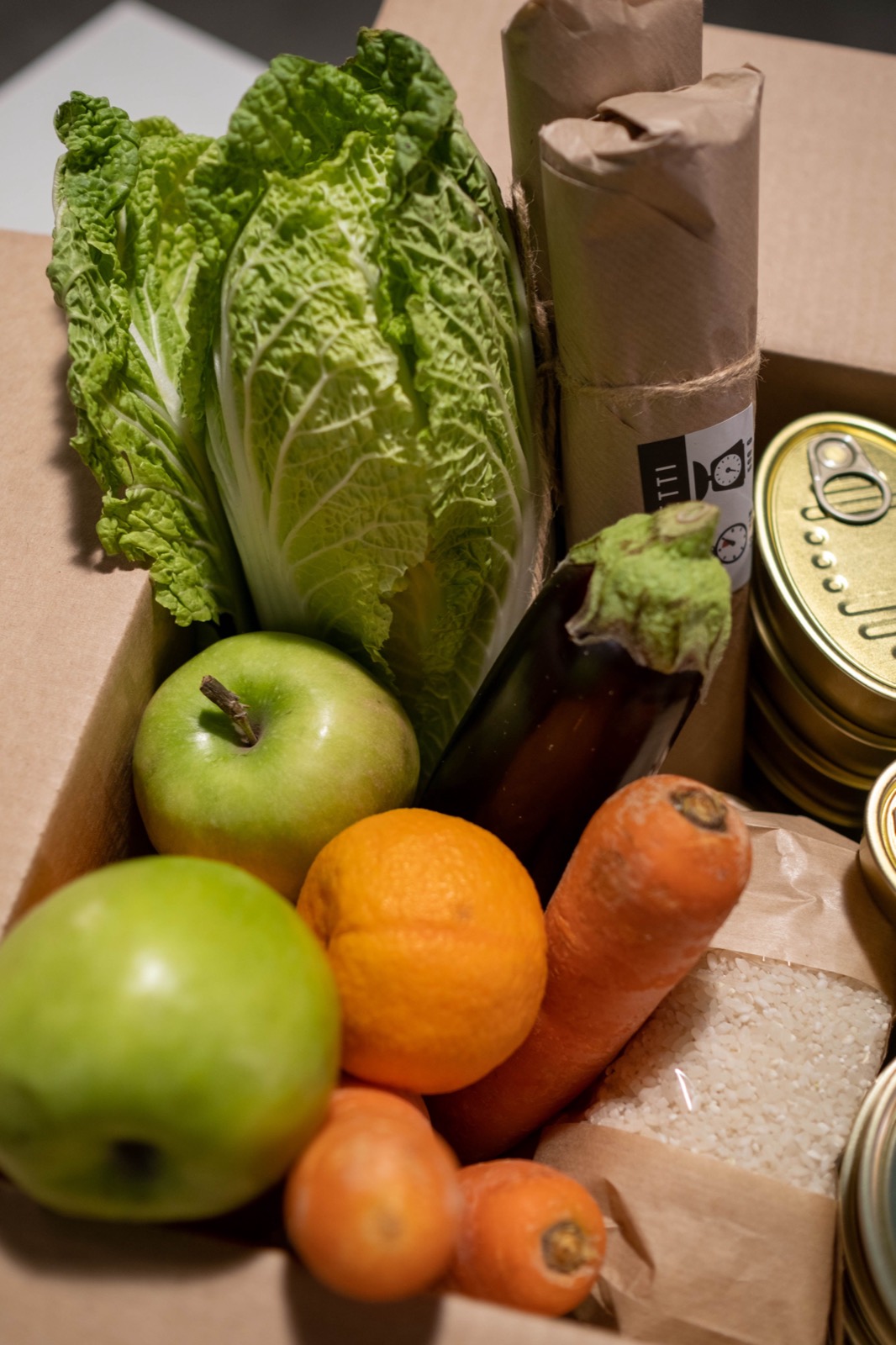 A box of donated groceries, black and white