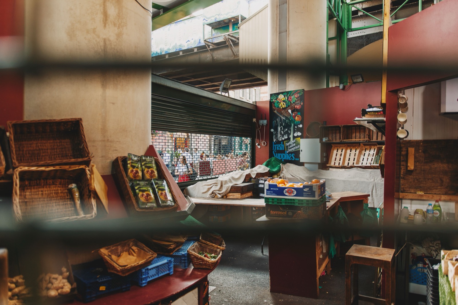 A market stall shuttered behind a grille